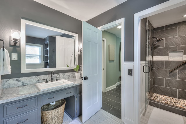 bathroom with tile patterned flooring, vanity, and a shower with shower door