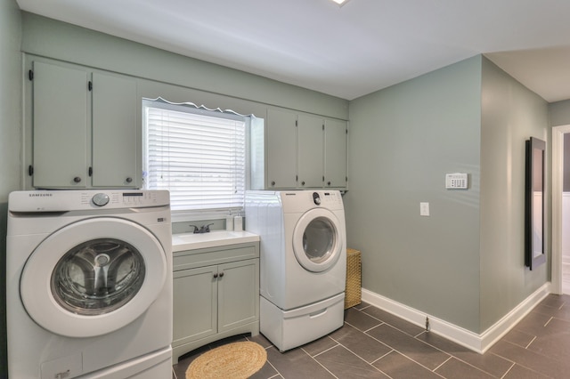 laundry room featuring cabinets, washing machine and dryer, and sink