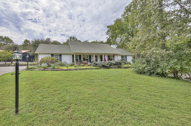 ranch-style home featuring a front yard