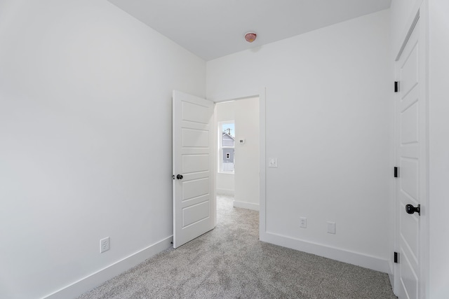 unfurnished bedroom featuring light carpet