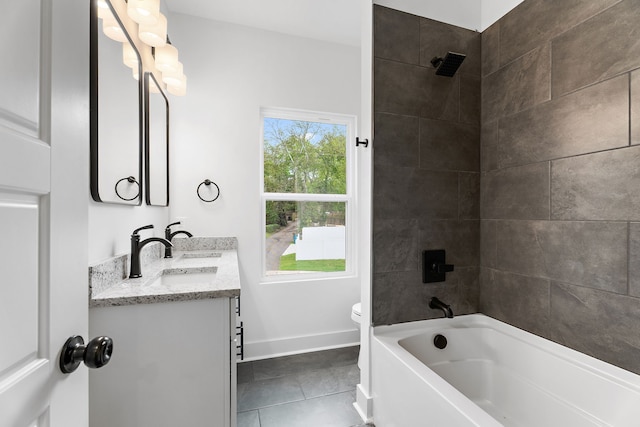 full bathroom with tiled shower / bath, vanity, toilet, and tile patterned floors