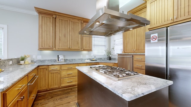 kitchen with hardwood / wood-style flooring, wall chimney range hood, stainless steel appliances, ornamental molding, and light stone countertops