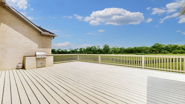 wooden terrace featuring area for grilling