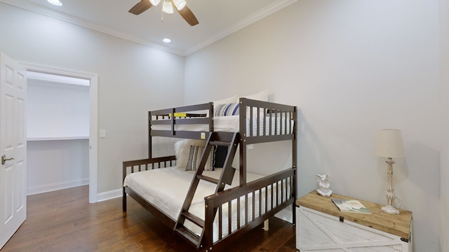 bedroom featuring ornamental molding, ceiling fan, and dark wood-type flooring