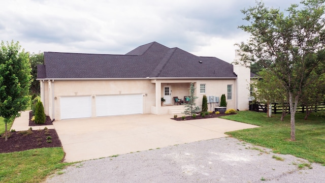 view of front of property with a garage and a front lawn