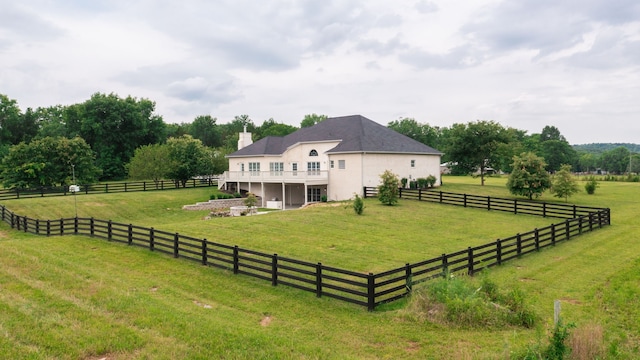 exterior space featuring a rural view and a yard