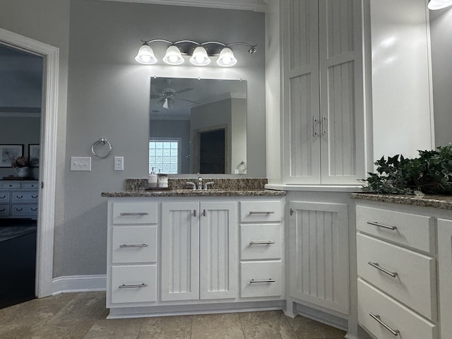 bathroom with ornamental molding, ceiling fan, and vanity