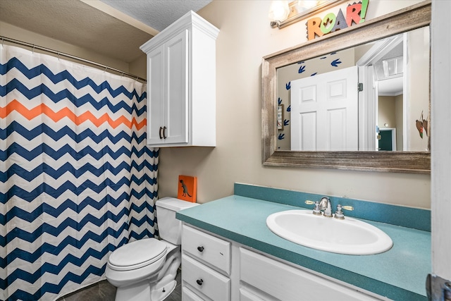 bathroom featuring walk in shower, vanity, toilet, and a textured ceiling