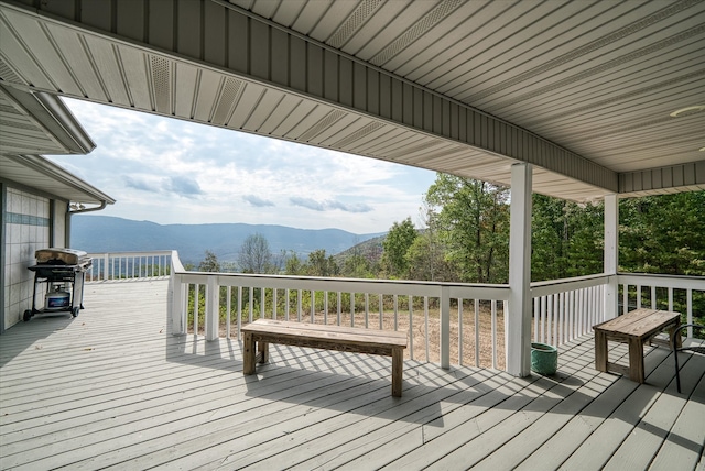 wooden terrace with a mountain view and a grill