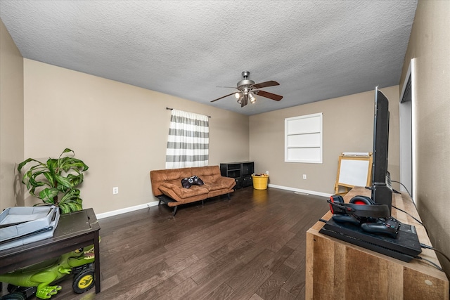 living room with ceiling fan, a textured ceiling, and dark hardwood / wood-style flooring