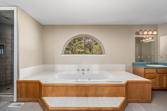 bathroom featuring vanity, shower with separate bathtub, and tile patterned floors