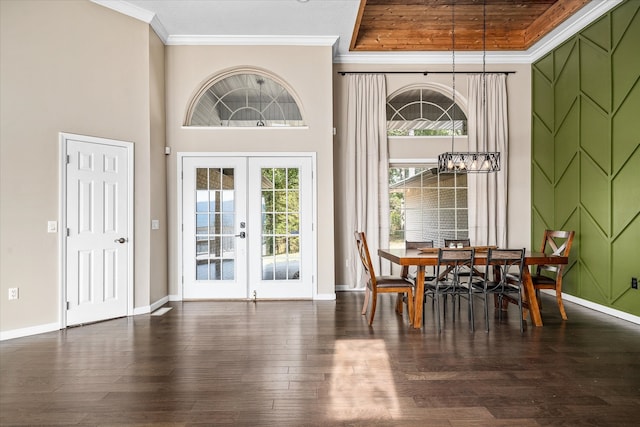 dining room with a high ceiling, crown molding, french doors, and dark hardwood / wood-style flooring