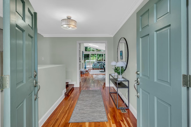 entryway with light hardwood / wood-style flooring and crown molding