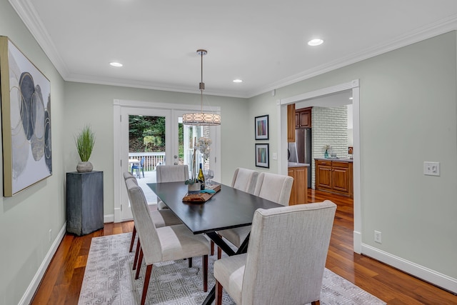 dining room featuring french doors, crown molding, and light hardwood / wood-style floors