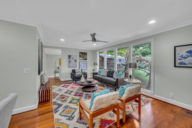 living room with ceiling fan, ornamental molding, and hardwood / wood-style floors