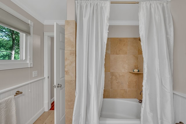 bathroom with ornamental molding and shower / tub combo with curtain