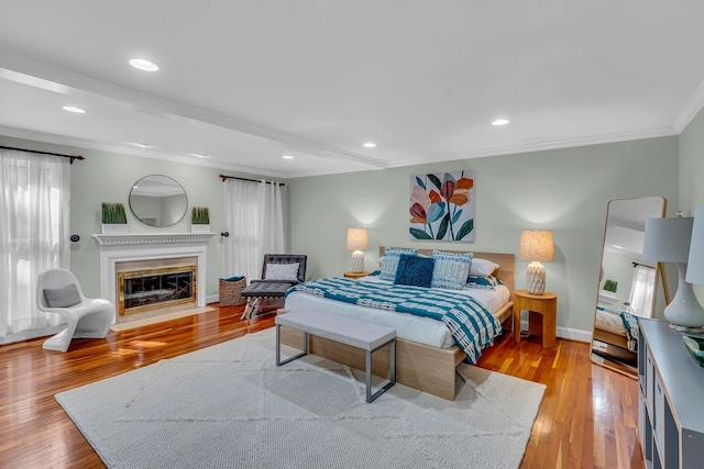 bedroom with light wood-type flooring and crown molding