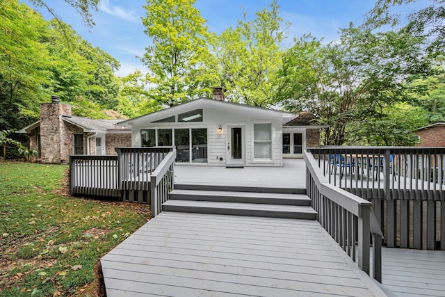 rear view of house featuring a wooden deck