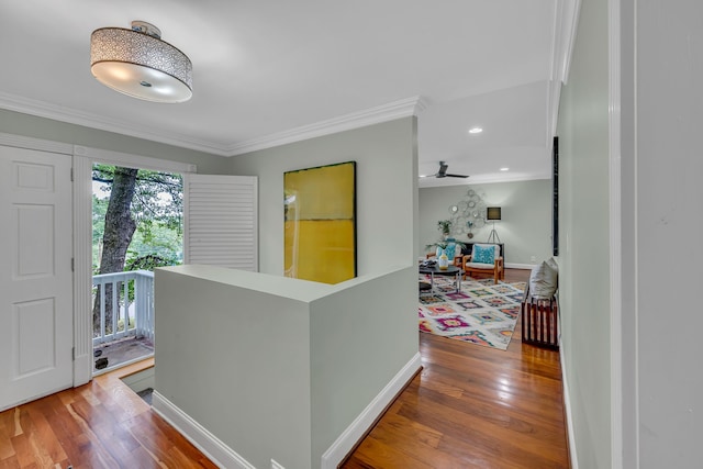 hallway with wood-type flooring and crown molding