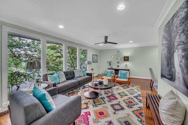 living room featuring ceiling fan, hardwood / wood-style flooring, and ornamental molding