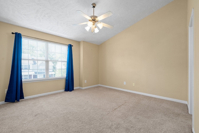 unfurnished room with vaulted ceiling, ceiling fan, light colored carpet, and a textured ceiling