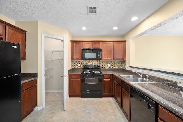 kitchen featuring backsplash, black appliances, a textured ceiling, and sink