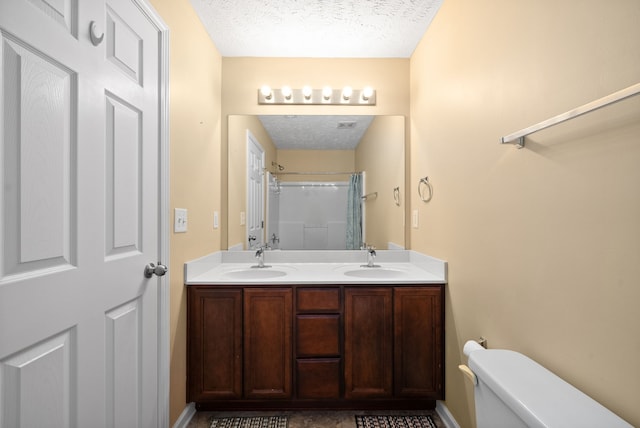 bathroom with walk in shower, vanity, toilet, and a textured ceiling