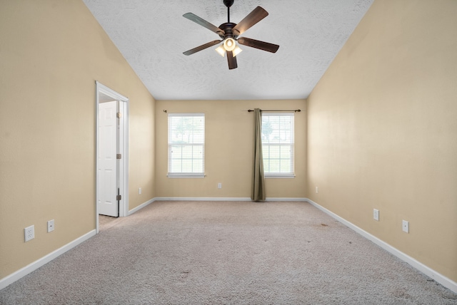 carpeted empty room featuring ceiling fan, a textured ceiling, and lofted ceiling