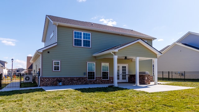 rear view of house featuring a yard, ceiling fan, and a patio area