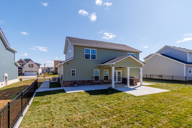 back of house featuring a yard, a patio area, and french doors