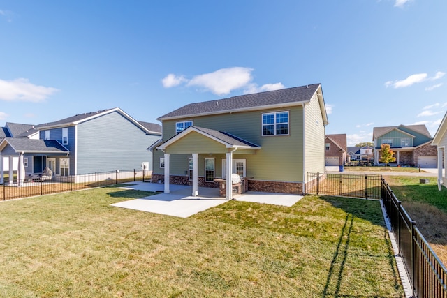 rear view of house featuring a yard and a patio area