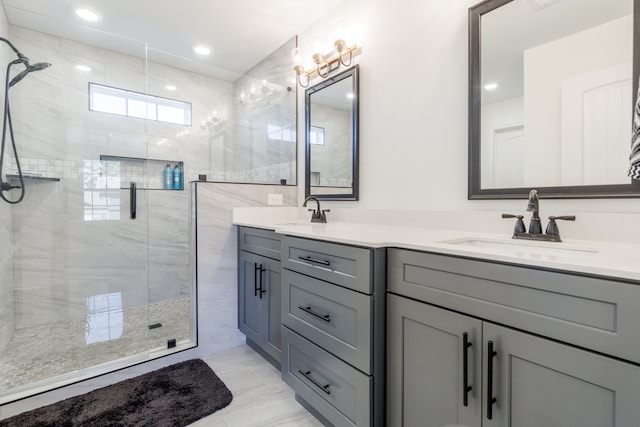 bathroom with vanity and a shower with door