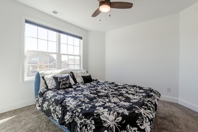 bedroom featuring ceiling fan and carpet