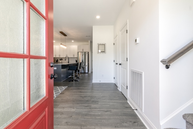 hallway with dark hardwood / wood-style floors and sink