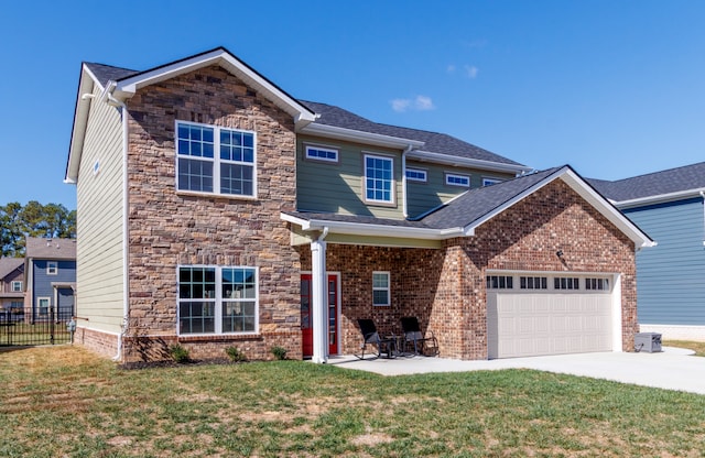 view of front of property featuring a garage, a patio area, and a front lawn