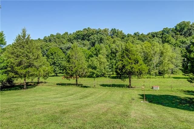 surrounding community with a yard and a rural view