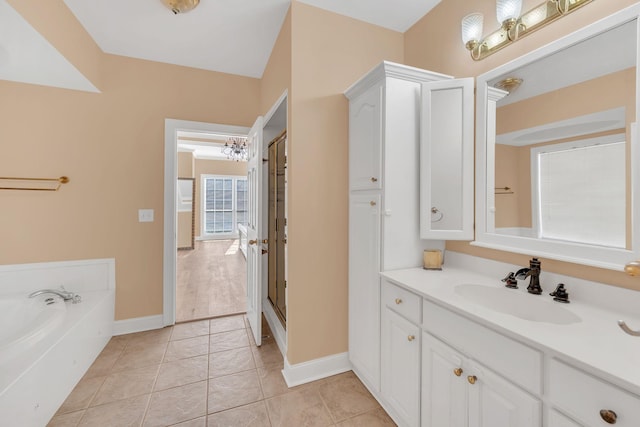 bathroom featuring vanity, tile patterned flooring, and a washtub