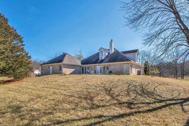 back of house with a lawn