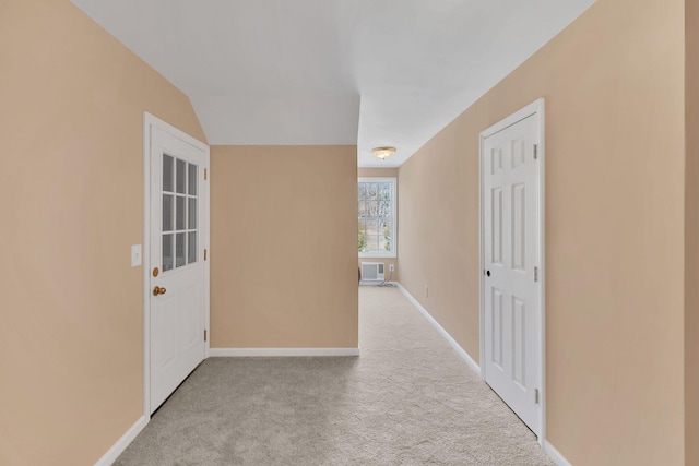 hallway featuring light carpet and a wall mounted air conditioner