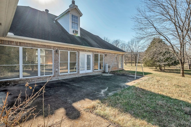 rear view of house with a patio area and a lawn