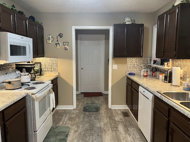 kitchen featuring a textured ceiling, backsplash, dark hardwood / wood-style floors, and white appliances