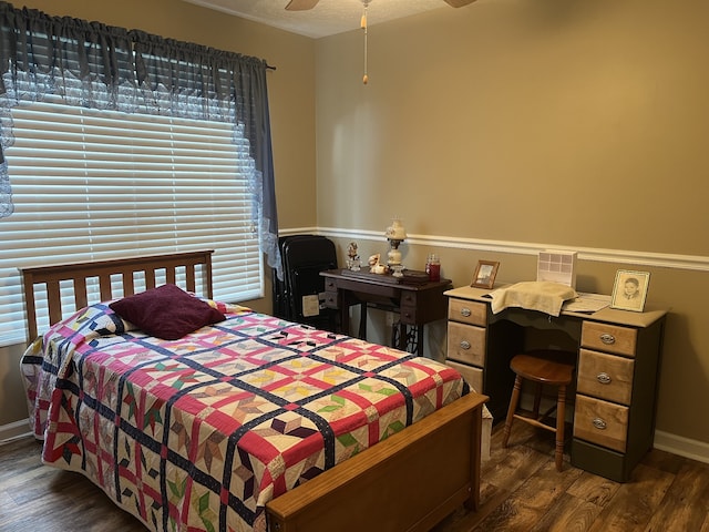 bedroom featuring ceiling fan, a textured ceiling, dark wood-type flooring, and multiple windows