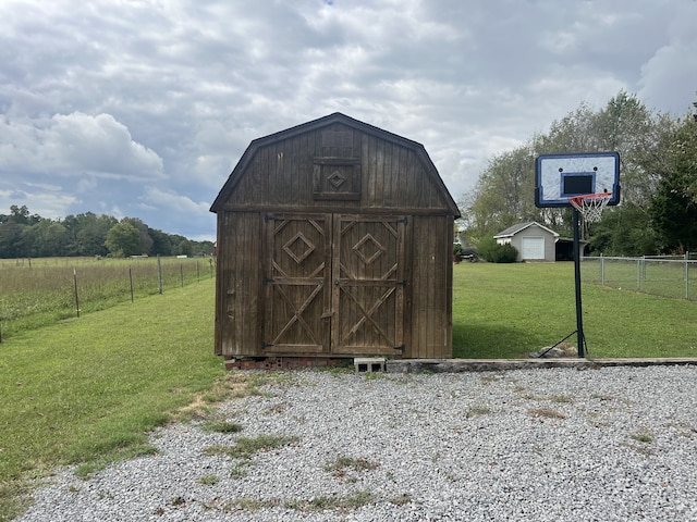 view of outdoor structure featuring a rural view and a yard