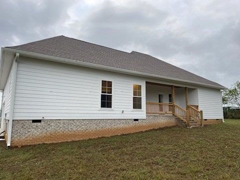 rear view of house with a lawn