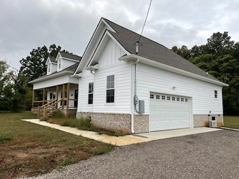 view of home's exterior with a porch and a garage