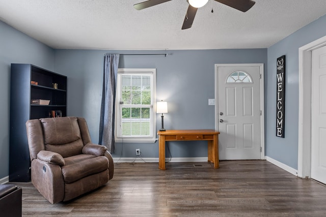 foyer with a textured ceiling, dark hardwood / wood-style floors, and ceiling fan