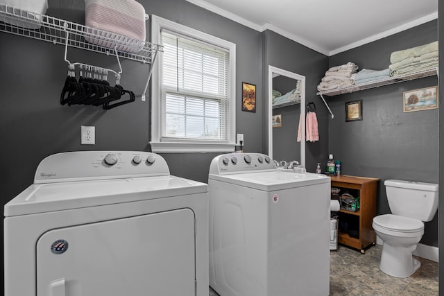 laundry area with washer and dryer and crown molding