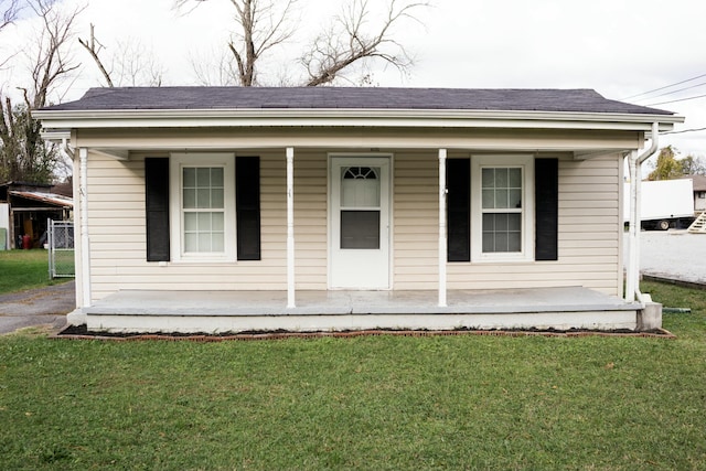 view of front of home with a front yard and a porch