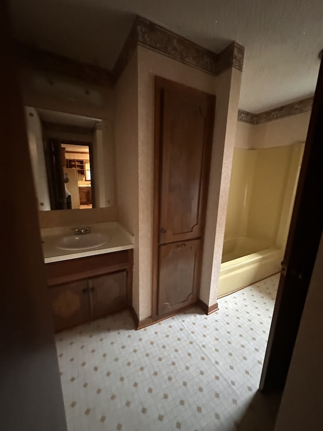 bathroom featuring walk in shower and vanity