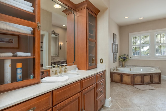 bathroom with a bathing tub, tile patterned flooring, and vanity